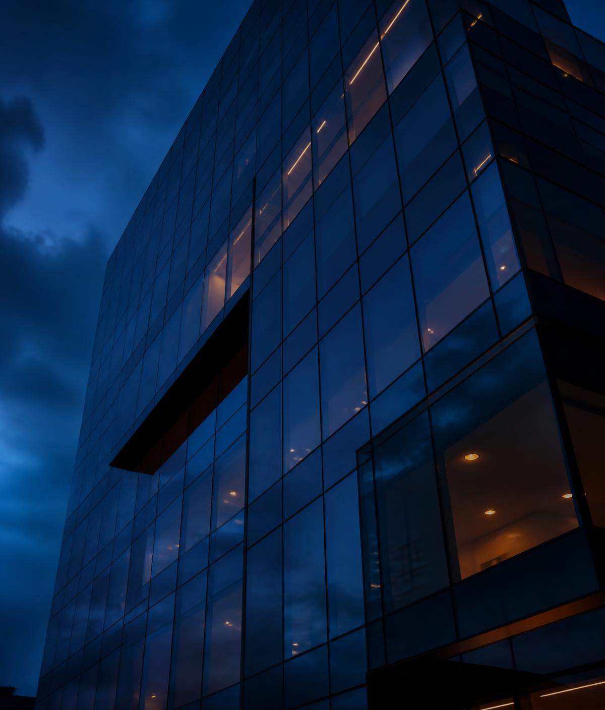 Glass office tower at dusk